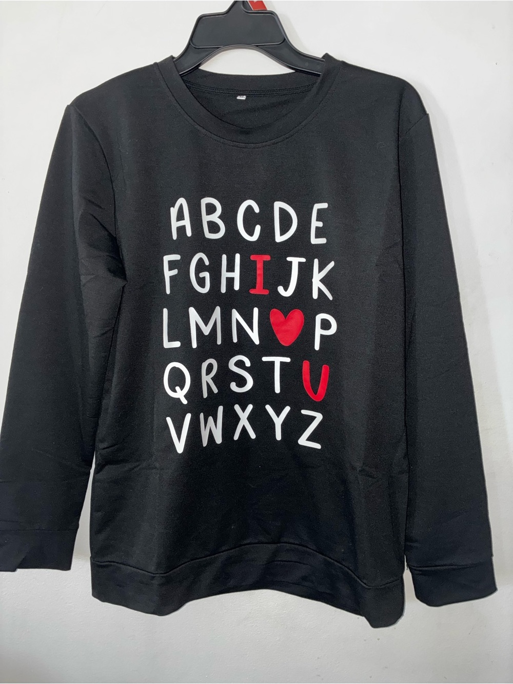 Black Crewneck Sweater with Alphabet Graphic and Red Accents